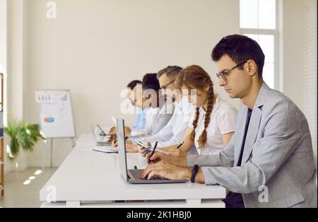 Group of business people or corporate employees working in modern office workplace Stock Photo