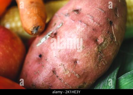 Macro shot of a raw potato among other vegetables. Stock Photo