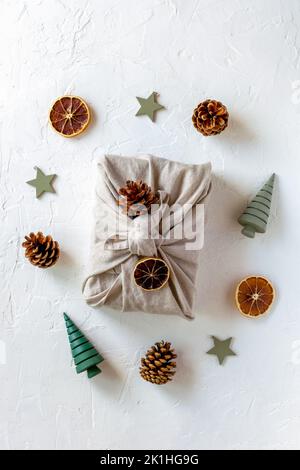 Christmas gift packed in textile, with the natural materials decoration, zero waste concept, top view Stock Photo