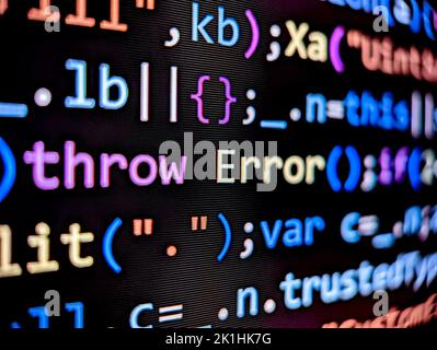 Computer code with error displayed on pixelated screen with colorful words on dark a background Stock Photo