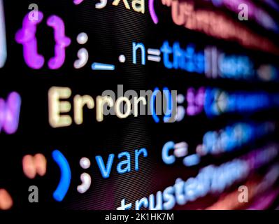 Error message displayed in computer code on pixelated screen with colorful words on a dark background Stock Photo
