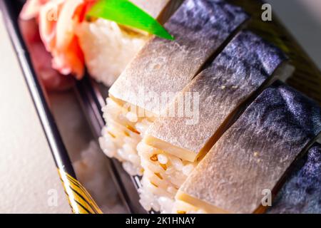 Saba Sushi (Saba Oshizushi, Mackerel Pressed Sushi). Oshi Zushi is a form of sushi which made by compressing sushi rice with fish and toppings Stock Photo