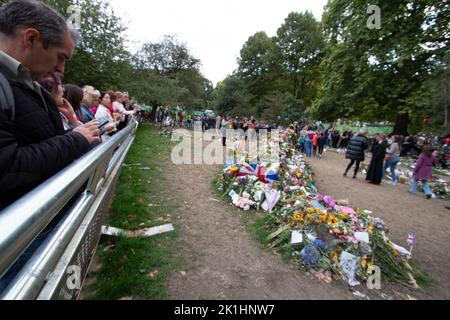 People looking at and photographing the floral tributes laid in Green Park after the death of the Queen, 18 September 2022, London, England UK Stock Photo
