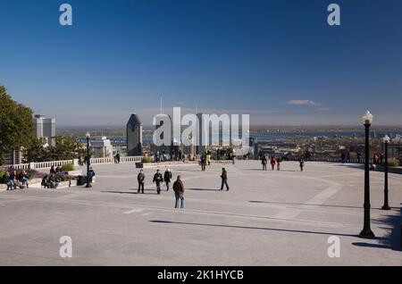 Tourists at lookout on Mount-Royal and Montreal skyline in autumn, Quebec, Canada. Stock Photo
