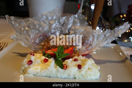 Famous Turkish traditional dessert ‘Gullac’ on the dessert plate. Stock Photo