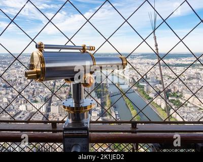 Paris, France - 18 April 2022: One of the coin-operated vintage telescopes at the observation platform on top of Eiffel tower. Stock Photo