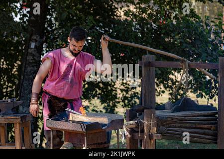 Blacksmith breeds medieval objects with the help of blacksmithing and tools, in Santa Maria da Feira fair Stock Photo