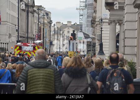 State funeral of Her Majesty Queen Elizabeth II, London, UK, Monday 19th September 2022. Photographer standing on a services box on Pall Mall taking a photograph of crowds of people with an elevated view. Stock Photo