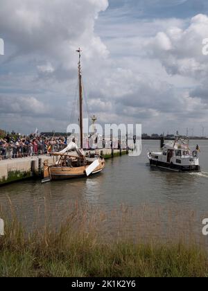 Doel, Belgium, 21 August 2022, Many people on the quay for the inauguration of boats and ships, vertical photo Stock Photo