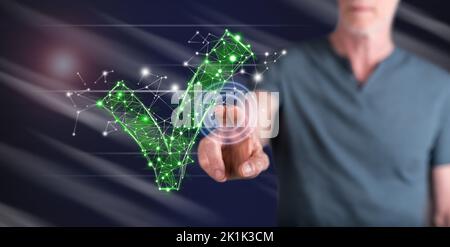 Man touching a validation concept on a touch screen with his finger Stock Photo