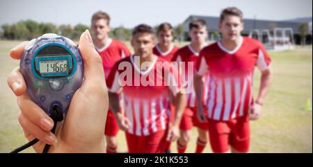 Composite image of close up of a hand holding a timer on a white background Stock Photo