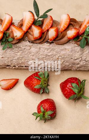 Chocolate roll with strawberries. Swiss roll cake Stock Photo