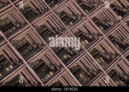 Pleasing symmetrical pattern formed by concrete reinforcement steel metal meshes, iron rods used for increased strength in cast concrete applications Stock Photo