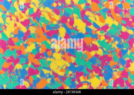 Sponge texture background with a multi coloured textured effect with all the colours of a pattern rainbow such as red, yellow, green, blue, orange and Stock Photo