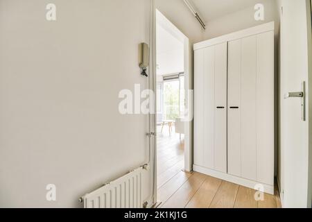 Interior of narrow corridor with telephone in daylight Stock Photo