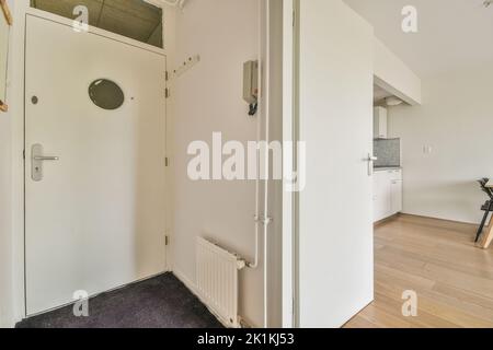 Interior of narrow corridor with telephone in daylight Stock Photo