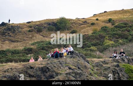 Edinburgh, Scotland, UK. 19th September 2022. Members of the public gather in Holyrood Park to watch live screening on big screen of funeral of Queen Elizabeth II from Westminster Abbey.   Iain Masterton/Alamy Live News Stock Photo