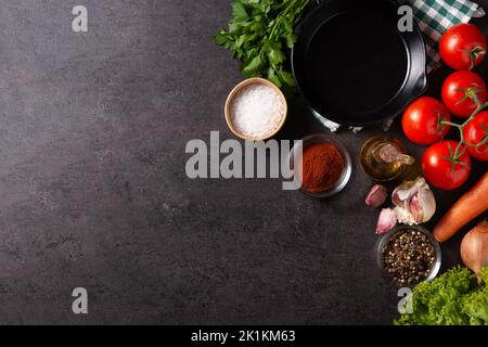 Assortment of vegetables, herbs and spices on black background. Top view. Copy space Stock Photo