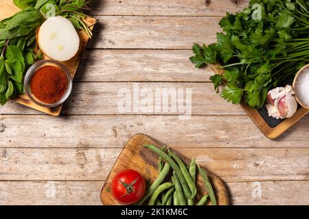 Assortment of vegetables, herbs and spices on wooden table. Top view. Copy space Stock Photo