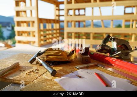 Close up of construction tools inside of unfinished wooden house. Stock Photo