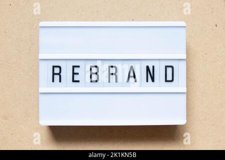 Lightbox with word rebrand on wood background Stock Photo