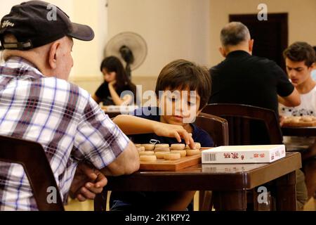 Bkenaya, Lebanon. 18th Sep, 2022. Participants compete in the game of Chinese chess, also called Xiangqi, organized by the XiangQi Committee in Lebanon in Bkenaya, Mount Lebanon Governorate, Lebanon, on Sept. 18, 2022. Credit: Bilal Jawich/Xinhua/Alamy Live News Stock Photo