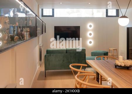 Modern basement interior design. Open space of living and dining room with blue sofa Stock Photo