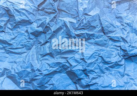 crumpled paper art textured background blue colored folded abstract ground. High quality photo Stock Photo