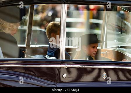 London, UK.  19 September 2022. The Queen Consort, Prince George and Princess Charlotte ride in a car following the coffin of the late Queen Elizabeth II carried on The State Gun Carriage of the Royal Navy, drawn by 142 sailors, in a procession in Whitehall after her state funeral in Westminster Abbey. The Queen will be buried alongside her husband Prince Philip in King George VI Memorial Chapel, Windsor Castle.   Credit: Stephen Chung / Alamy Live News Stock Photo