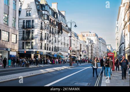 London, United Kingdom - September 17 2022: West End with Adelphi theatre and Vaudeville theatre on the left, crowds of people walking Stock Photo