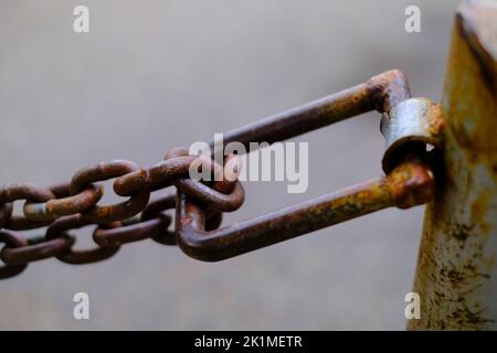 Detail of chain connected to pole for security and protection Stock Photo