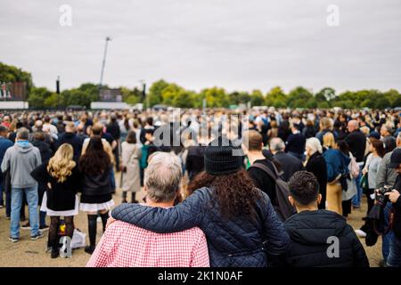 London, UK. 19th Sep, 2022.   Two people embracing in Hyde Park as they watch the funeral of Queen Elizabeth II from the big screens Credit: Massimiliano Donati/Alamy Live News Stock Photo