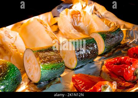 Healthy eating. Vegetables baked in the oven. Pepper and zucchini with a ruddy crust are prepared in the oven. Stock Photo