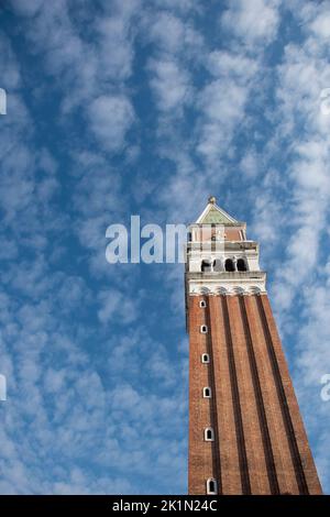 Vertical view of the bell tower of St. Mark's Square in Venice against the blue sky. Stock Photo