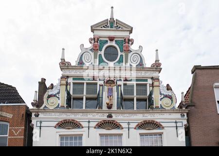 Facade historical renaissance step gabled house in the inner city of Coevorden (with one modern statuette of a girl in the middle) Netherlands Stock Photo