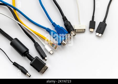 Various types of cable connectors for electronic devices isolated in white. Stock Photo