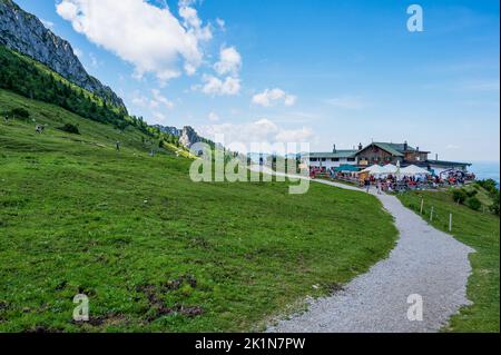 Aschau, Bavaria, Germany - July 14, 2020: tourists visiting the Steinlingalm in front of the Kampenwand, a mountain in Bavaria, Germany Stock Photo