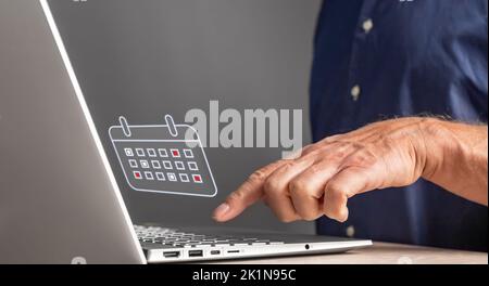 Man looking at calendar on laptop. Forefinger at keyboard closeup. Work planning, schedule of business events, activities, meetings, agenda preparing. Stock Photo