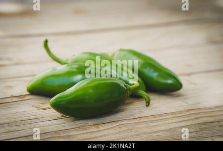 Jalapeño Peppers, green on a wooden board. Stock Photo