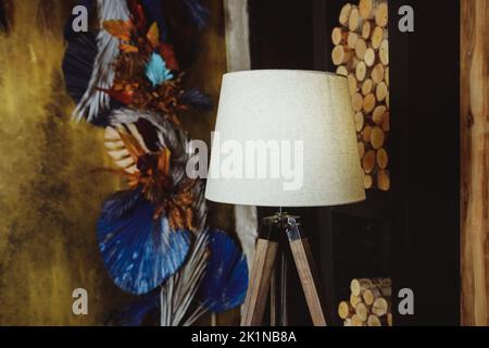 Wooden floor lamp isolated on blurred background. Interior design Inspiration. Home living. Home decoration and decorative lampshade Stock Photo