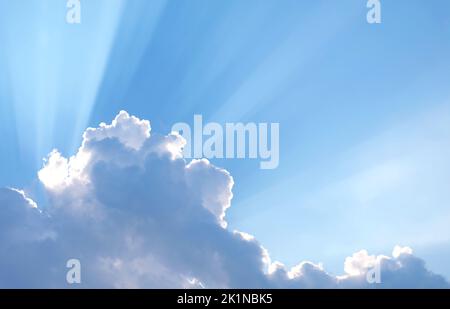 Fantastic Sunbeam Shining Through the Fluffy Clouds Stock Photo