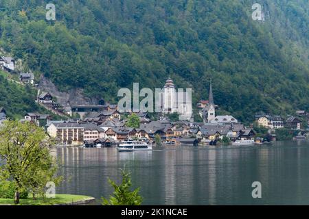 View of Hallstatt a world famous market town in the Salzkammergut region of Upper Austria with catholic protestant church and Hallstatt lake and excur Stock Photo