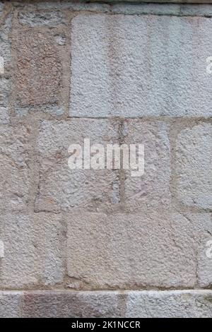 Close up white beige historic old structured bricked facade wall as background with stone blocks rectangular shaped Stock Photo