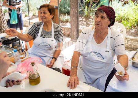 Stall holders selling traditional Cypriot produce at the Statos-Ayios Fotios Rural Festival, Cyprus. Stock Photo