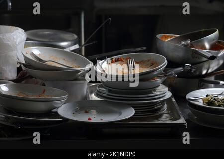 restaurant and catering - dirty dishes and dishes to wash in the kitchen Stock Photo