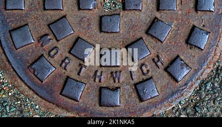 Embossed cast iron grid, grate, drain cover - Northwich, Cheshire, England, UK, CW8 1AD Stock Photo