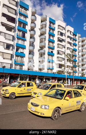 Bogota Colombia,Calle 24a Ciudad Salitre,condominium apartment building outside exterior taxi cabs yellow traffic,Colombian Colombians Hispanic Hispan Stock Photo