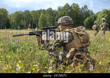 U.S. Marine Corps Lance Cpl. Seth Smith, automatic rifleman, 1st Battalion, 8th Marine Regiment, 2d Marine Division, engages targets with his M27 Infantry Automatic Rifle, during a live fire and movement range during exercise Archipelago Endeavor 22 (AE22) on Berga Naval Base, Sweden, Sept. 14, 2022. AE22 is an integrated field training exercise that increases operational capability and enhances strategic cooperation between the U.S. Marines and Swedish forces. (U.S. Marine Corps photo by 1st Lt. William Reckley) Stock Photo