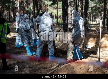 September 19, 2022, Izium, Kharkiv region, Ukraine: On the outskirts of Izium, mass graves with more than 400 bodies of civilians, who died as a result of Russian occupation were found when the city was liberated by Ukrainian armed forces a week earlier. Exhumations of bodies, buried in these graves are performed since then. 200 bodies of civilians were already exhumed. (Credit Image: © Danylo Antoniuk/ZUMA Press Wire) Stock Photo