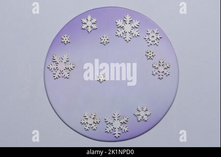 Round background with snowflakes on purple blue color surface Stock Photo